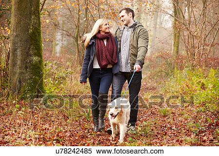 Couple Walking Dog Through Winter Woodland View Large Photo Image Stock Photography - Couple Walking Dog Through Winter Woodland. Fotosearch