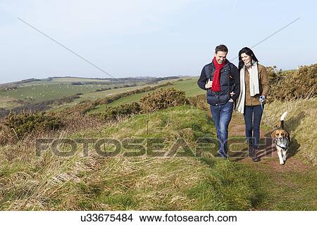 Couple With Dog Walking Along Coastal Path View Large Photo Image Picture - Couple With Dog Walking Along Coastal Path. Fotosearch