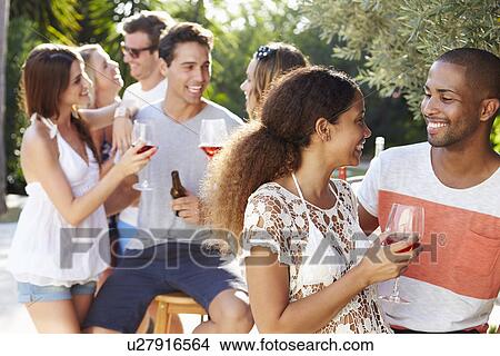 Couple With Friends Drinking Wine And Relaxing Outdoors View Large Photo Image Picture - Couple With Friends Drinking Wine And Relaxing Outdoors. Fotosearch
