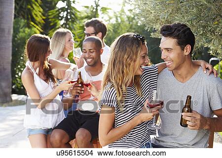 Picture - Couple With Friends Drinking Wine And Relaxing Outdoors. Fotosearch