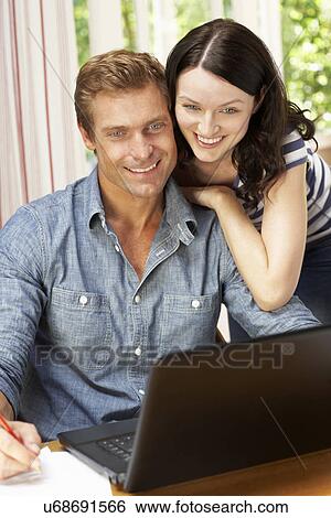 Stock Photograph - Couple Working In Home Office. Fotosearch