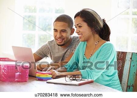 Stock Photo - Couple Working In Office At Home. Fotosearch
