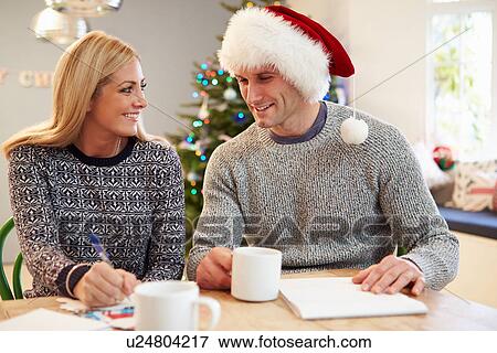 Couple Writing Christmas Cards Together View Large Photo Image Stock Photo - Couple Writing Christmas Cards Together. Fotosearch