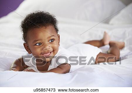 Cute Baby Lying On Tummy In Parent's Bed View Large Photo Image Stock Image - Cute Baby Lying On Tummy In Parent's Bed. Fotosearch