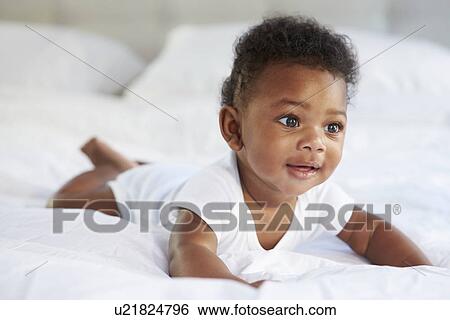 Cute Baby Lying On Tummy In Parent's Bed View Large Photo Image Stock Photograph - Cute Baby Lying On Tummy In Parent's Bed. Fotosearch