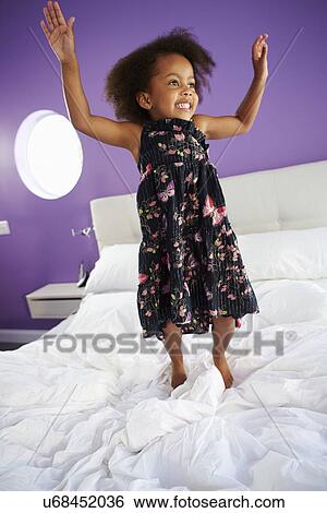 Cute Little Girl Jumping On Parent's Bed View Large Photo Image Stock Photograph - Cute Little Girl Jumping On Parent's Bed. Fotosearch