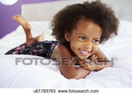 Cute Little Girl Lying On Tummy In Parent's Bed View Large Photo Image Stock Image - Cute Little Girl Lying On Tummy In Parent's Bed. Fotosearch