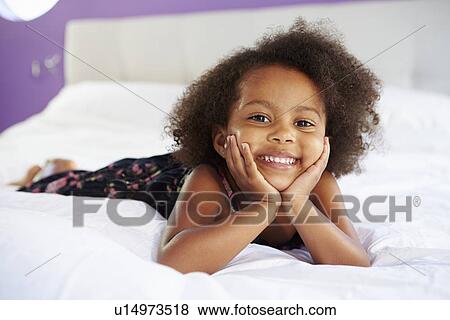 Cute Little Girl Lying On Tummy In Parent's Bed View Large Photo Image Stock Photo - Cute Little Girl Lying On Tummy In Parent's Bed. Fotosearch