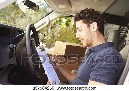 Delivery Driver Sitting In Van Filling Out Paperwork View Large Photo Image Stock Image - Delivery Driver Sitting In Van Filling Out Paperwork. Fotosearch