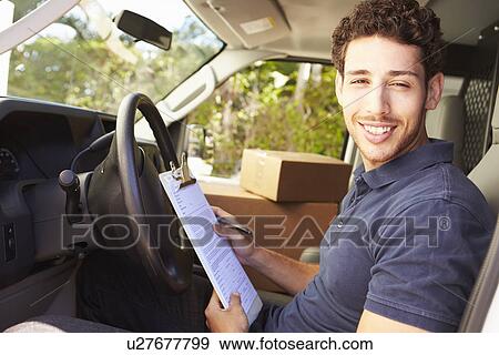 Delivery Driver Sitting In Van Filling Out Paperwork View Large Photo Image Stock Photo - Delivery Driver Sitting In Van Filling Out Paperwork. Fotosearch