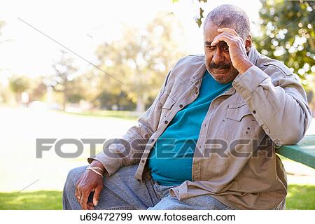 Stock Photo - Depressed Senior Man Sitting Outside. Fotosearch