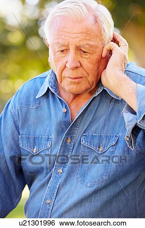 Stock Photograph - Depressed Senior Man Sitting Outside. Fotosearch