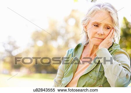 Stock Photography - Depressed Senior Woman Sitting Outside. Fotosearch