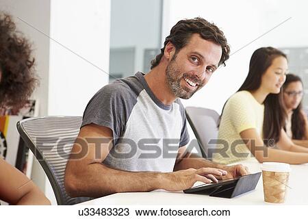 Stock Image - Design Team Collaborating On Project Together. Fotosearch