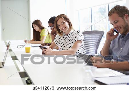 Stock Image - Design Team Collaborating On Project Together. Fotosearch