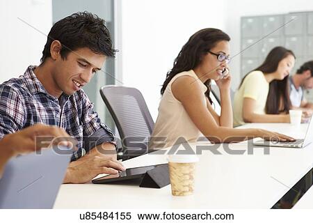 Stock Photography - Design Team Collaborating On Project Together. Fotosearch