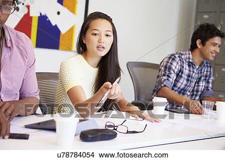 Picture - Designers Meeting To Discuss New Ideas. Fotosearch