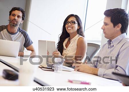 Stock Image - Designers Meeting To Discuss New Ideas. Fotosearch