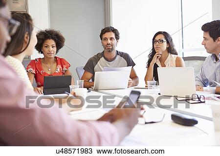 Stock Image - Designers Meeting To Discuss New Ideas. Fotosearch