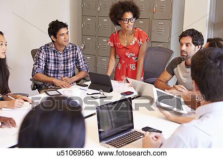 Stock Image - Designers Meeting To Discuss New Ideas. Fotosearch