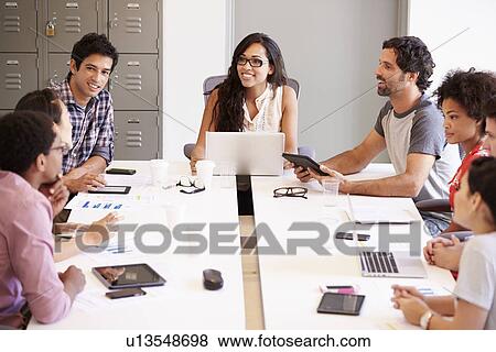 Stock Photo - Designers Meeting To Discuss New Ideas. Fotosearch