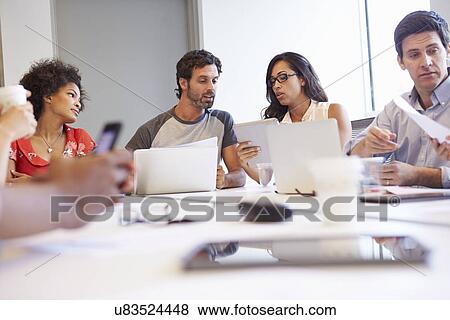 Stock Photo - Designers Meeting To Discuss New Ideas. Fotosearch