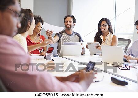 Stock Photography - Designers Meeting To Discuss New Ideas. Fotosearch
