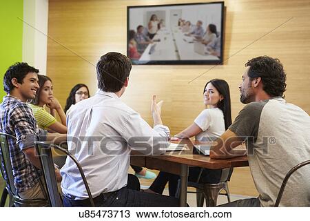 Designers Sitting Around Table In Meeting Looking At Screen View Large Photo Image Stock Image - Designers Sitting Around Table In Meeting Looking At Screen. Fotosearch