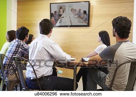 Designers Sitting Around Table In Meeting Looking At Screen View Large Photo Image Stock Photograph - Designers Sitting Around Table In Meeting Looking At Screen. Fotosearch