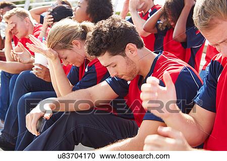 Stock Image - Disappointed Spectators In Team Colors Watching Sports Event. Fotosearch