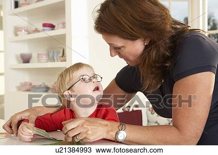 Stock Image - Downs Syndrome boyhaving speech therapy. Fotosearch