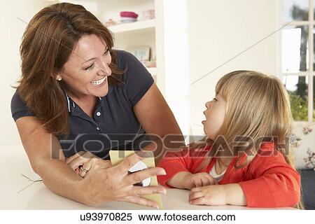 Stock Photography - Downs Syndrome girl having speech therapy. Fotosearch