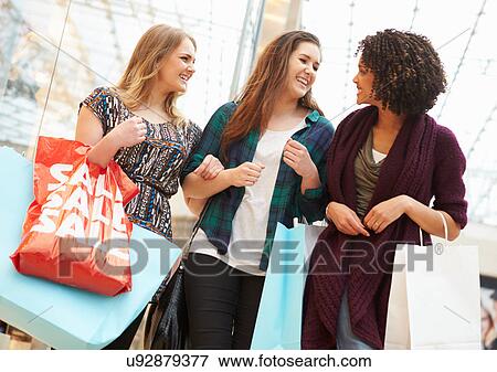 Excited Female Shoppers With Sale Bags In Mall View Large Photo Image Stock Photo - Excited Female Shoppers With Sale Bags In Mall. Fotosearch