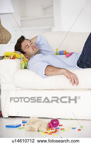Stock Image - Exhausted father sleeping. Fotosearch