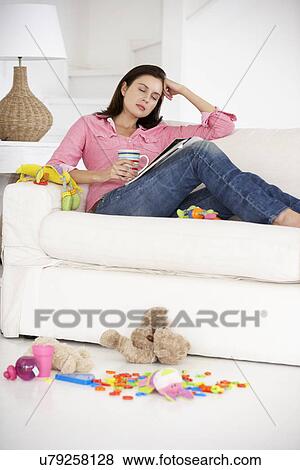 Stock Photo - Exhausted mother enjoying a rest. Fotosearch