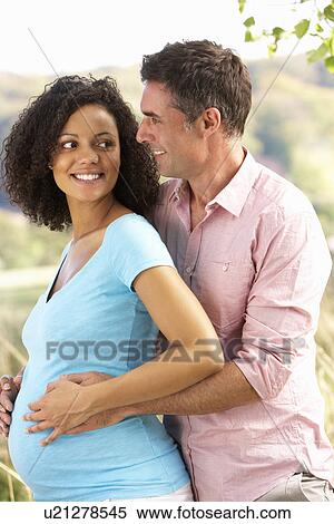Stock Photography - Expectant couple outdoors in countryside. Fotosearch