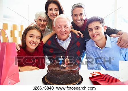 Stock Image - Family Celebrating 70th Birthday Together. Fotosearch