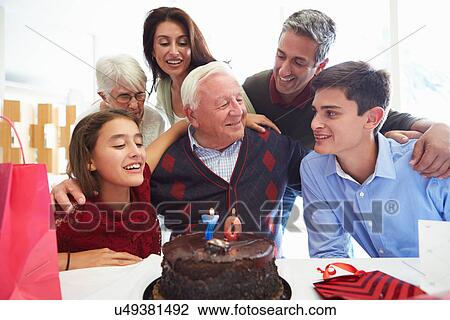 Stock Image - Family Celebrating 70th Birthday Together. Fotosearch