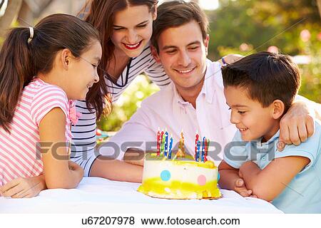 Family Celebrating Birthday Outdoors With Cake View Large Photo Image Stock Photo - Family Celebrating Birthday Outdoors With Cake. Fotosearch