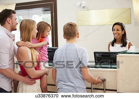 Family Checking In At Hotel Reception View Large Photo Image Stock Image - Family Checking In At Hotel Reception. Fotosearch