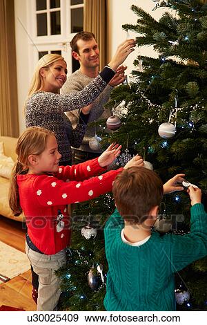 Family Decorating Christmas Tree At Home Together View Large Photo Image Stock Photo - Family Decorating Christmas Tree At Home Together. Fotosearch