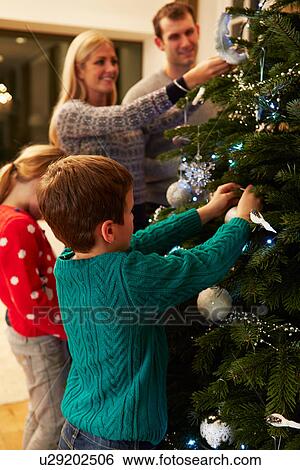 Family Decorating Christmas Tree At Home Together View Large Photo Image Stock Photograph - Family Decorating Christmas Tree At Home Together. Fotosearch