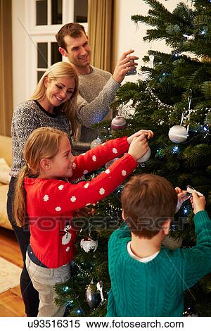 Family Decorating Christmas Tree At Home Together View Large Photo Image Stock Photography - Family Decorating Christmas Tree At Home Together. Fotosearch