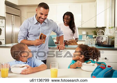 Stock Photo - Family Eating Breakfast At Home Together. Fotosearch