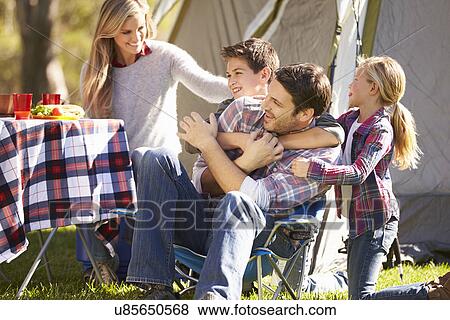 Stock Photo - Family Enjoying Camping Holiday In Countryside. Fotosearch