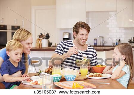 Family Enjoying Meal At Home Together View Large Photo Image Stock Photo - Family Enjoying Meal At Home Together. Fotosearch