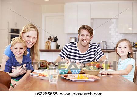 Family Enjoying Meal At Home Together View Large Photo Image Stock Photography - Family Enjoying Meal At Home Together. Fotosearch