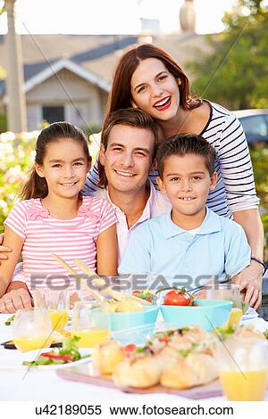 Stock Photography - Family Enjoying Outdoor Meal In Garden. Fotosearch