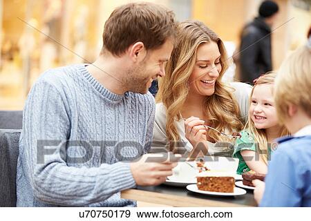 Stock Photo - Family Enjoying Snack In Cafe Together. Fotosearch