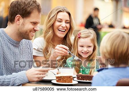 Stock Photography - Family Enjoying Snack In Cafe Together. Fotosearch